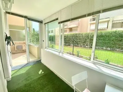 an empty room with windows and green grass at Cannes Résidence Passy avec Piscine in Cannes