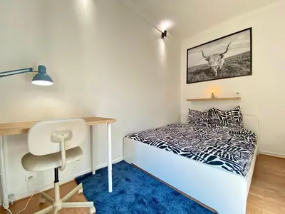 a small bedroom with a bed and a desk at Volupté By SCLS Locations in Cannes
