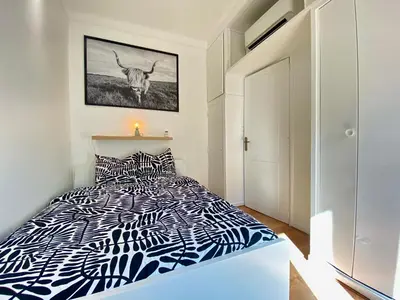 a bedroom with a bed with a cow on the wall at Volupté By SCLS Locations in Cannes