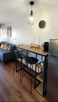 a kitchen and living room with a table and chairs at Appartement proche de la plage in Cannes