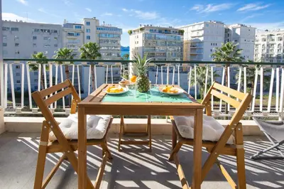 a table and chairs on a balcony with a view of buildings at Croisette et Plages - Lumineux deux pièces - FW in Cannes