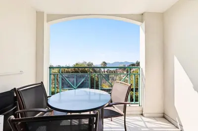 a corridor of a building with a green railing at Résidence Cannes Villa Francia - maeva Home - Appartement 2 pièces 4 personnes - Sélection MAE-0091 in Cannes