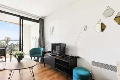 a living room with a tv and a table at Résidence Cannes Villa Francia - maeva Home - Appartement 2 pièces 4 personnes - Sélection MAE-0091 in Cannes