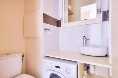 a bathroom with a sink and a washing machine at Résidence Cannes Villa Francia - maeva Home - Appartement 2 pièces 5 personnes - Prestige MAE-8991 in Cannes