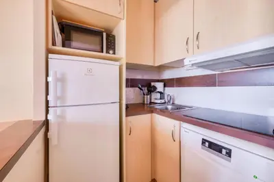 a kitchen with a white refrigerator and a sink at Résidence Cannes Villa Francia - maeva Home - Appartement 2 pièces 5 personnes - Prestige MAE-8991 in Cannes