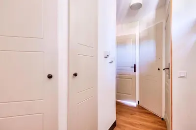 a hallway with white doors and wooden floors at Résidence Cannes Villa Francia - maeva Home - Appartement 2 pièces 5 personnes - Sélection MAE-9021 in Cannes