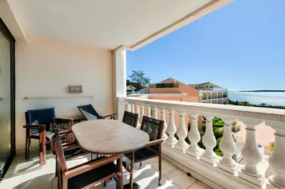 a balcony with a table and chairs and a view of the ocean at Résidence Cannes Villa Francia - maeva Home - Appartement 2 pièces 5 personnes - Sélection MAE-9021 in Cannes