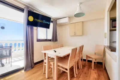 a kitchen and dining room with a table and chairs at Résidence Cannes Villa Francia - maeva Home - Appartement 2 pièces 5 personnes - Sélection MAE-9021 in Cannes