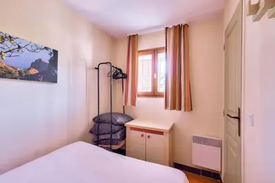 a bedroom with a bed and a chair in it at Résidence Cannes Villa Francia - maeva Home - Appartement 2 pièces 4 personnes - Sélection MAE-2351 in Cannes