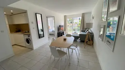 a kitchen and living room with a table and chairs at A022 Chic Cannes Flat Balcony Parking in Cannes