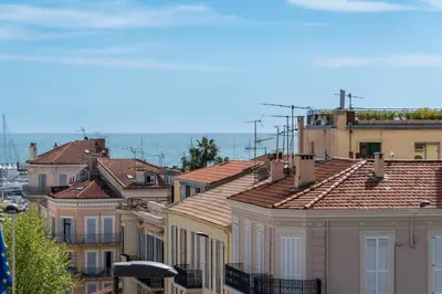 a group of buildings with the ocean in the background at Grand studio centre-ville cannes aperçu mer in Cannes