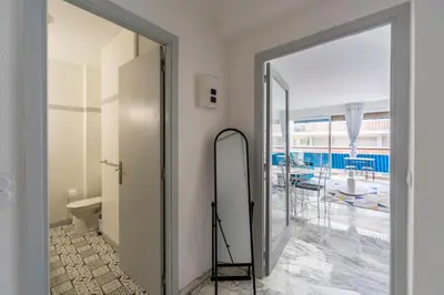 a bathroom with a mirror next to a door at Grand studio centre-ville cannes aperçu mer in Cannes