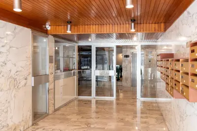 a lobby with glass doors and marble walls at Grand studio centre-ville cannes aperçu mer in Cannes