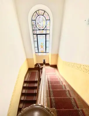 a staircase with a stained glass window in a building at Appartement Cosy in Le Cannet