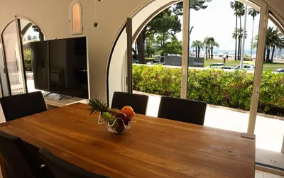 a dining room table with a bowl of fruit on it at Superbe Villa-Appartement sur la Croisette avec grande terrasse in Cannes