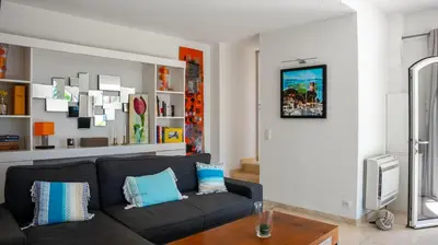 a living room with a couch and a table at Superbe Villa-Appartement sur la Croisette avec grande terrasse in Cannes