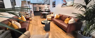 a living room with two couches and a table at Villa Le Loft by Festif Azur 4-Star 200m2 House with Garden, 5-Min Walk to Palais des Festivals and Beaches in Cannes