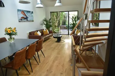 a living room with a table and chairs at Villa Le Loft by Festif Azur 4-Star 200m2 House with Garden, 5-Min Walk to Palais des Festivals and Beaches in Cannes