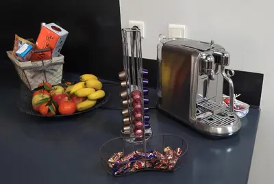 a counter with a toaster and a bowl of fruit at Villa Le Loft by Festif Azur 4-Star 200m2 House with Garden, 5-Min Walk to Palais des Festivals and Beaches in Cannes