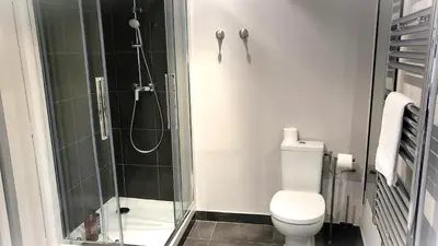 a bathroom with a toilet and a glass shower at Villa Le Loft by Festif Azur 4-Star 200m2 House with Garden, 5-Min Walk to Palais des Festivals and Beaches in Cannes