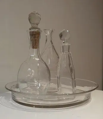 three glass vases on a glass plate on a table at Villa Le Loft by Festif Azur 4-Star 200m2 House with Garden, 5-Min Walk to Palais des Festivals and Beaches in Cannes