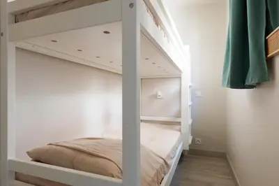 a white bunk bed in a room at Studio vue mer Cannes - Piscine - Tennis - Clim in Cannes