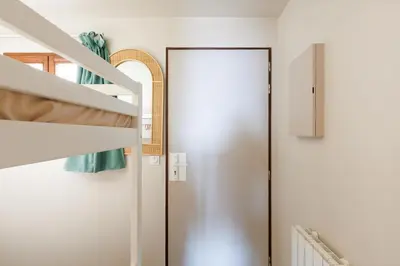a door in a room with a bed and a staircase at Studio vue mer Cannes - Piscine - Tennis - Clim in Cannes