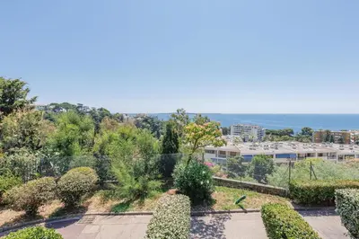 a view of the ocean from a building at Studio vue mer Cannes - Piscine - Tennis - Clim in Cannes
