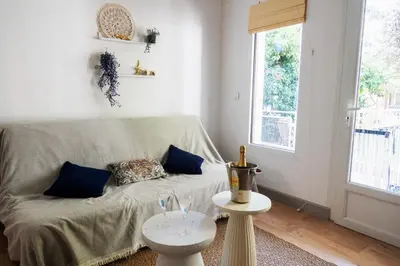 a living room with a couch and a window at La maison by Simone T3 in Cannes