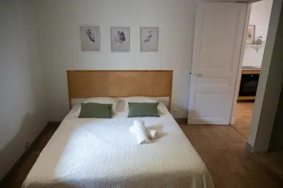 a white teddy bear sitting on top of a bed at La maison by Simone T3 in Cannes