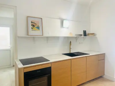 a kitchen with a sink and a stove top oven at La maison by Simone T3 in Cannes
