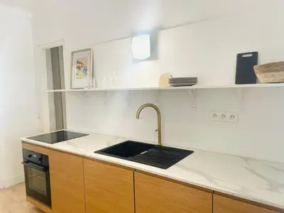 a kitchen with a sink and a counter top at La maison by Simone T3 in Cannes