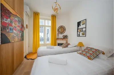 a bedroom with two beds and a window at B016 - Beautiful apt For 4 - Cannes center in Cannes