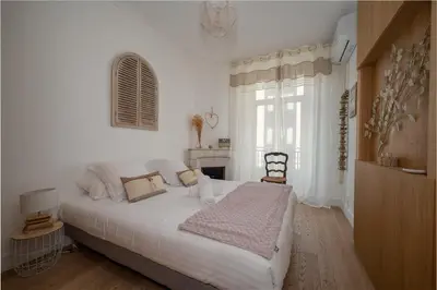 a white bedroom with a large bed and a window at B016 - Beautiful apt For 4 - Cannes center in Cannes