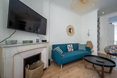 a living room with a blue couch and a fireplace at B016 - Beautiful apt For 4 - Cannes center in Cannes