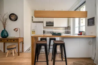 a kitchen with a counter and stools in a room at B016 - Beautiful apt For 4 - Cannes center in Cannes