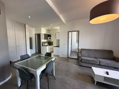 a living room with a couch and a table and chairs at B081 - Bel appartement Cannes - Tassigny in Cannes