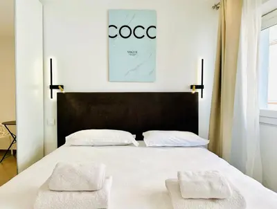 a bedroom with a bed with two towels on it at Renovated studio near the CROISETTE in Cannes