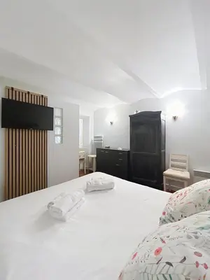 a bedroom with a white bed with two towels on it at Les Fleurs in Cannes