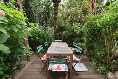 a wooden table and chairs on a wooden deck at Les Fleurs in Cannes