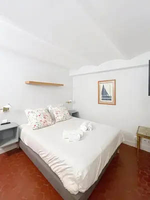a bedroom with a bed with two stuffed animals on it at Les Fleurs in Cannes
