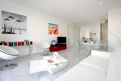 a white living room with a white couch and chairs at LA CROISETTE élégant studio avec balcon et vue mer aperçu in Cannes