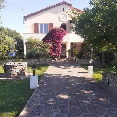 a house with a walkway in front of it at La fourmi in Cannes
