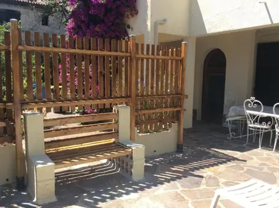a wooden bench sitting next to a building at La fourmi in Cannes