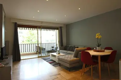 a living room with a couch and a table at Air-conditioned Apartment of 90 m2 only 200 meters away from the Croisette in Cannes