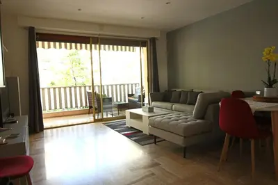 a living room with a couch and a table at Air-conditioned Apartment of 90 m2 only 200 meters away from the Croisette in Cannes