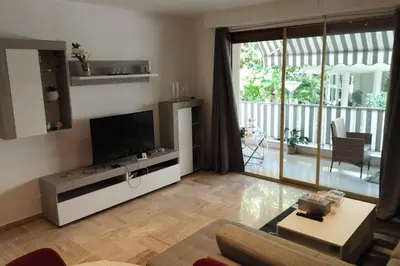a living room with a flat screen tv and a couch at Air-conditioned Apartment of 90 m2 only 200 meters away from the Croisette in Cannes