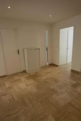 an empty room with two doors and a wooden floor at Air-conditioned Apartment of 90 m2 only 200 meters away from the Croisette in Cannes