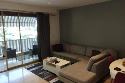 a living room with a couch and a table at Air-conditioned Apartment of 90 m2 only 200 meters away from the Croisette in Cannes