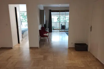 a living room with a wooden floor and a dining room at Air-conditioned Apartment of 90 m2 only 200 meters away from the Croisette in Cannes